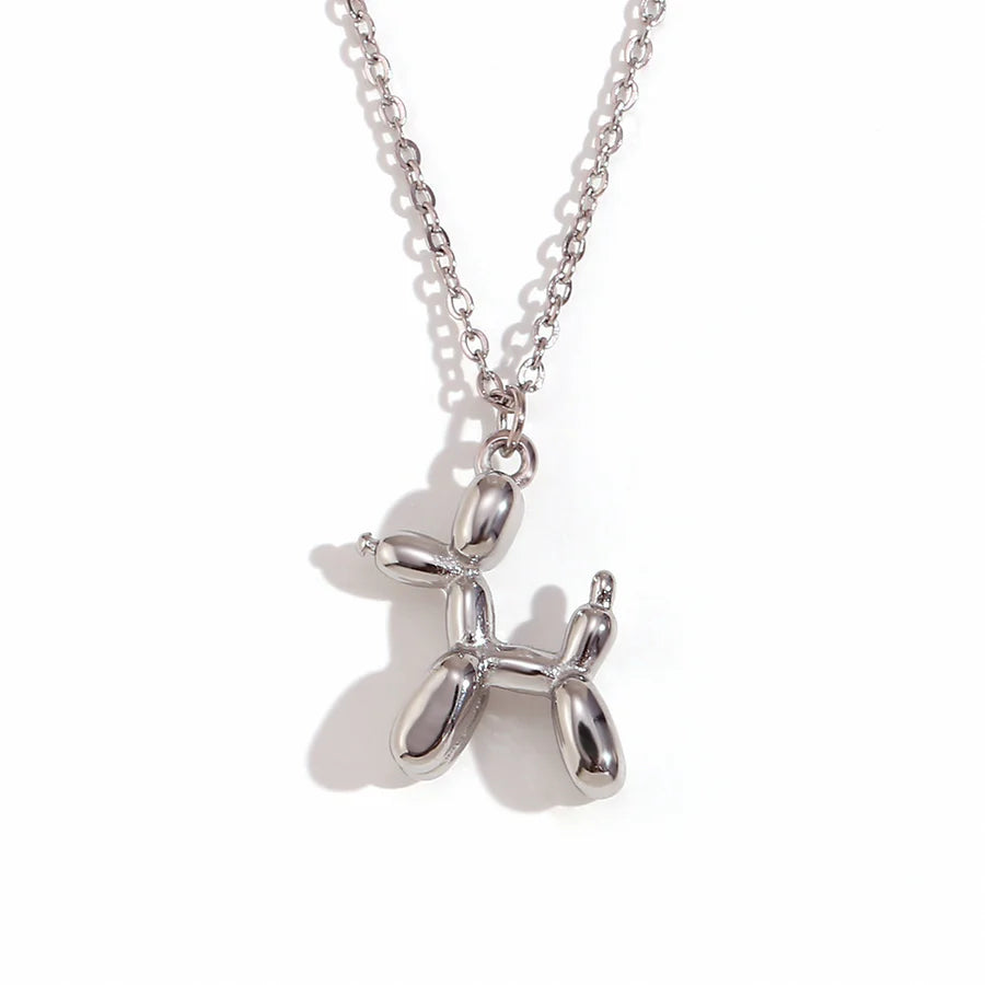 Silver dog-shaped pendant on a chain against a white background