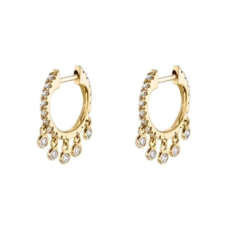 Gold hoop earrings with small diamonds on a white background