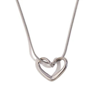 Minimalist silver heart knot pendant necklace on a snake chain, styled against a white background.